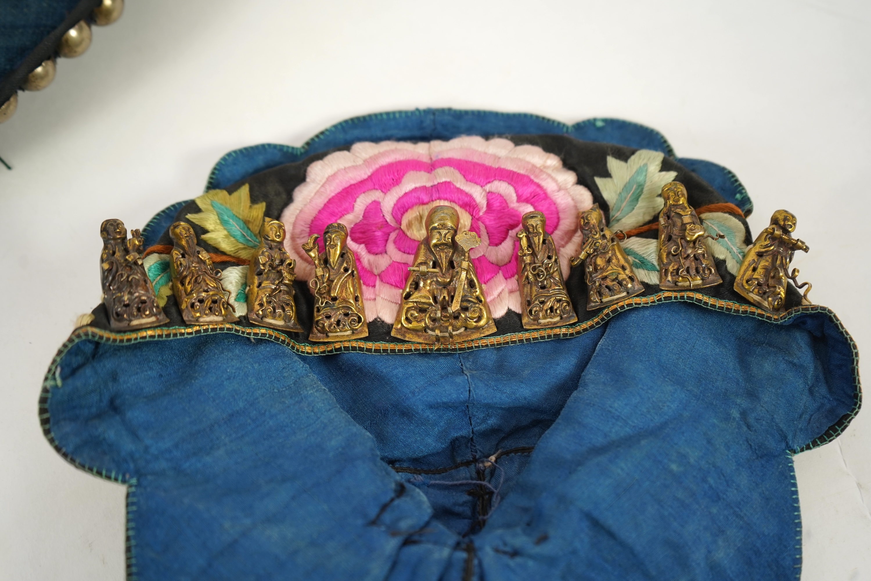 Two Chinese embroidered silk wedding skirts, late Qing, five hats, trousers, two skirt panels and two others, collar and a panel